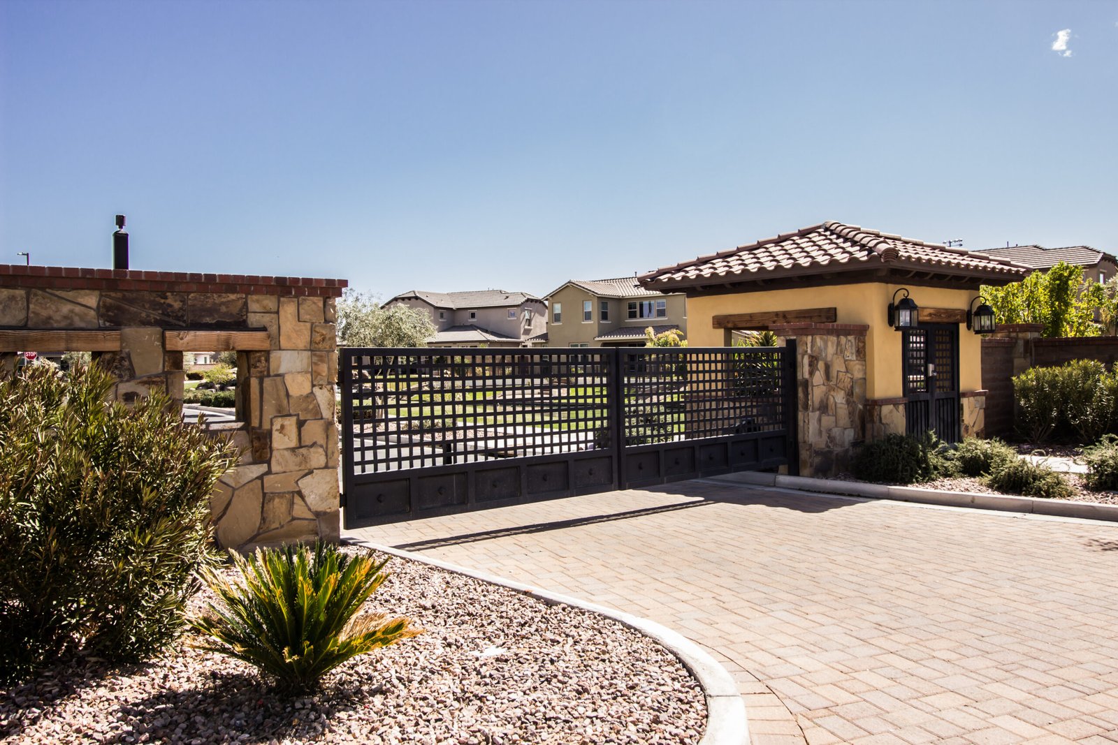 modern double metal entry gates with walk thru structure